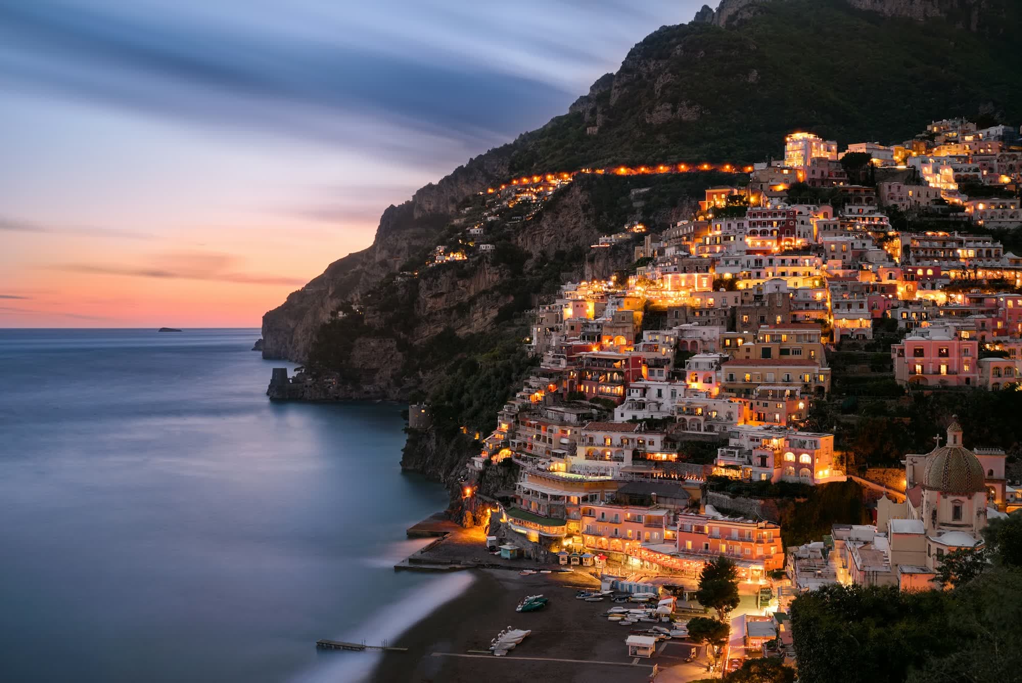 Positano lit up at dusk on the Amalfi Coast